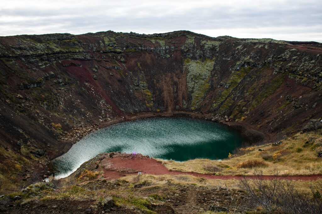 Explore the stunning Kerid Crater with its vibrant green lake set in Iceland