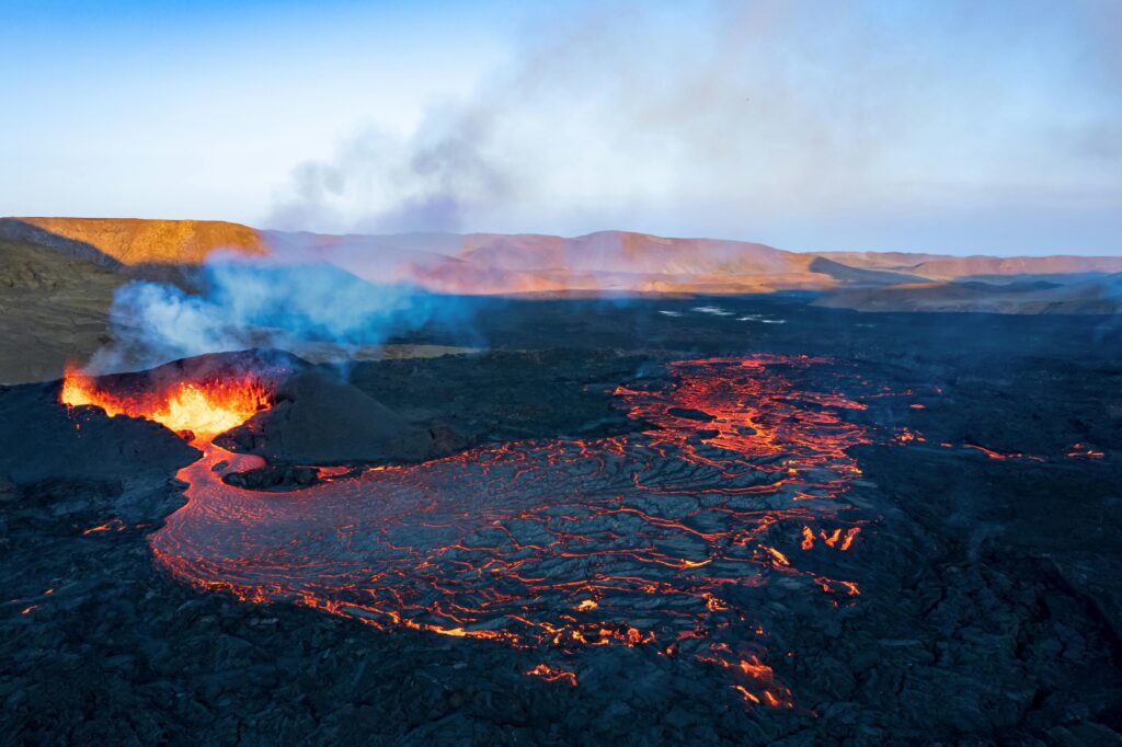 A breathtaking aerial shot of a volcanic eruption with flowing lava in Grindavik, Iceland.