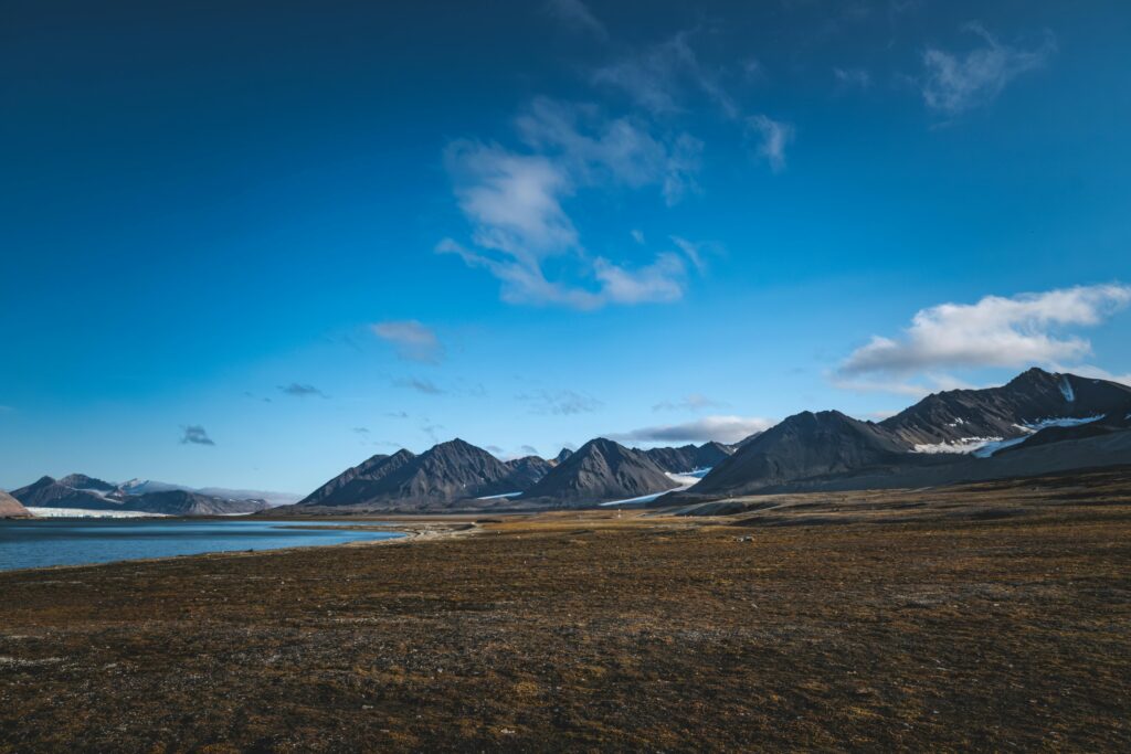 Majestic arctic landscape with rugged mountains and clear blue sky, perfect for nature and travel themes.