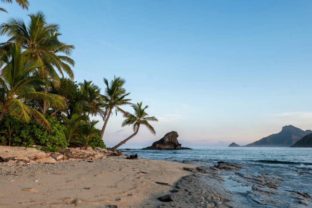 Experience the serene beauty of a tropical beach at sunrise on Kuata Island, Fiji.