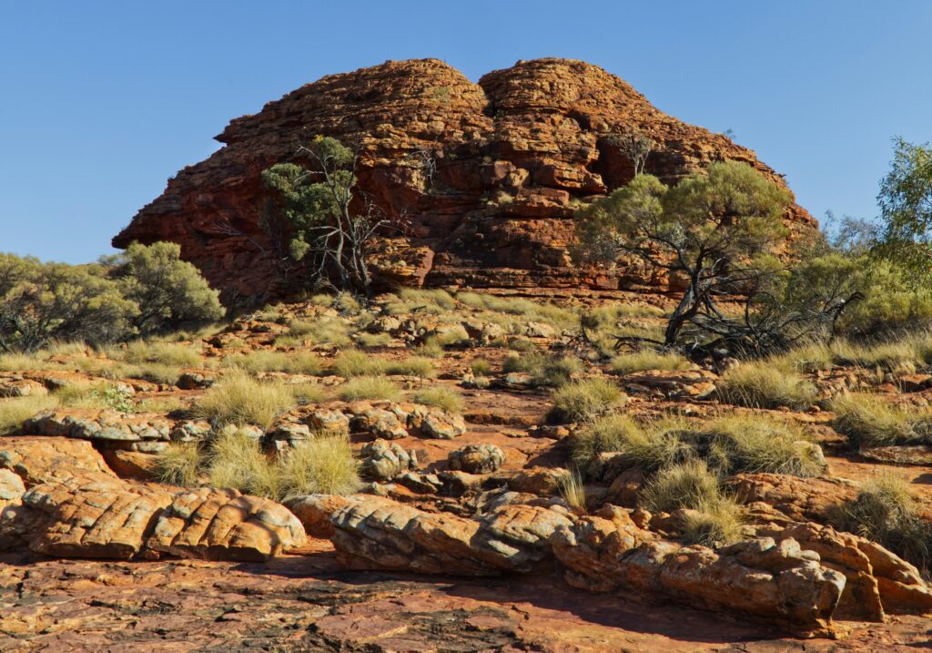 Explore breathtaking red rock formations and rugged desert landscape in Northern Territory, Australia.