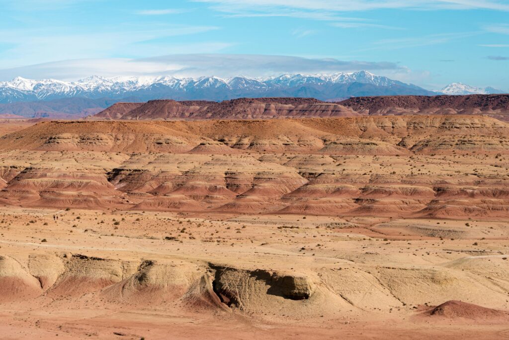Stunning view of Atlas Mountains with snow caps in the Moroccan desert landscape.