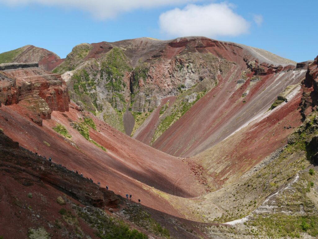 A breathtaking landscape of the Mount Tarawera crater in New Zealand, showcasing vibrant red terrain.