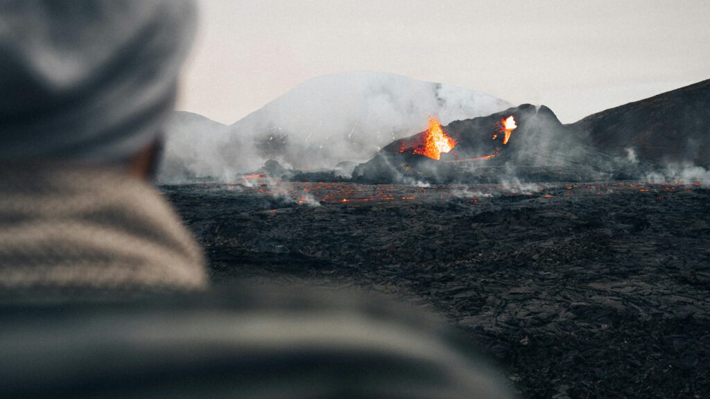A striking view of a volcanic eruption in Iceland with glowing lava and smoke.