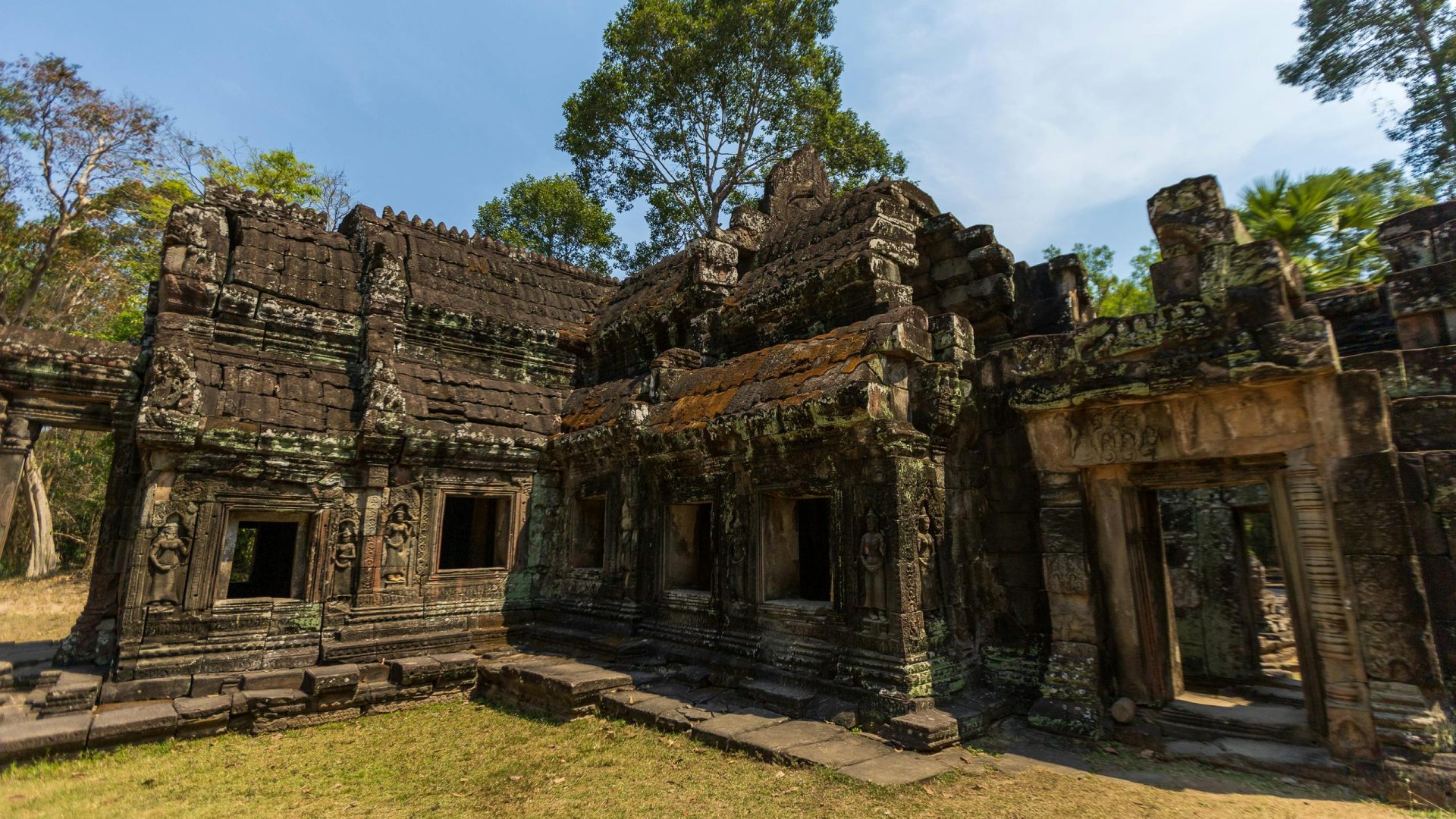 Explore the ancient ruins of the Angkor Wat complex in Cambodia, showcasing historical architecture.